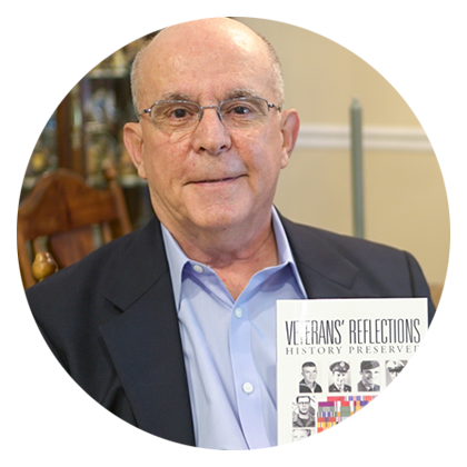 iUniverse author William Graser holding his published book Veterans' Reflections: History Preserved.